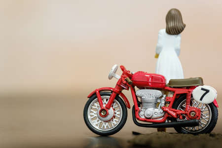 vintage red color motorbike and girl figure toy closeup viewの写真素材