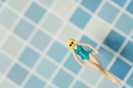 swimsuit Women plastic toy top view on blue backgroundの写真素材