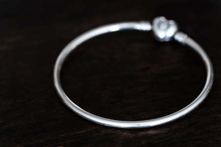 heart shape Silver bracelet isolated on wood backgroundの写真素材