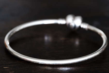heart shape Silver bracelet isolated on wood backgroundの写真素材