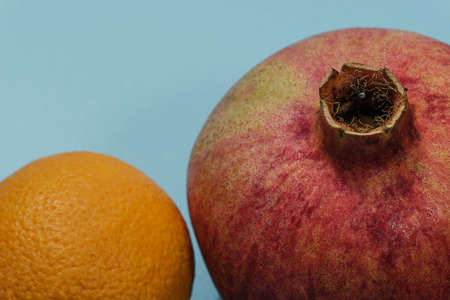 pomegranate and orange on blue background viewの写真素材