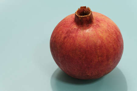 red pomegranate on blue background isolated viewの写真素材