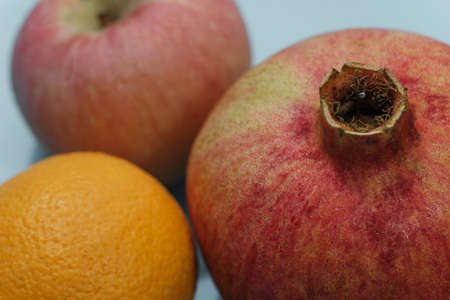 pomegranate apple and orange on blue background viewの写真素材