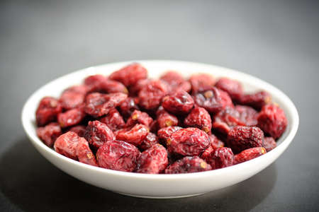 Closeup of a White plate Full of Dried Cranberriesの写真素材