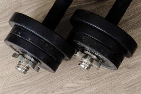 black color old rusty dumbbells on wood floorの写真素材