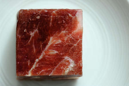 Fresh raw beef cubes isolated on white plateの写真素材