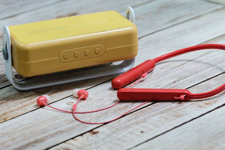 Stylish radio and earphone macro view on wood table backgroundの写真素材