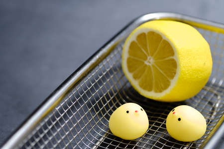 chicken toy with lemon in metal basketの写真素材