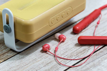 Stylish radio and earphone macro view on wood table backgroundの写真素材