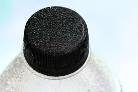 Close-up of plastic bottle, mineral water, bright backgroundの写真素材