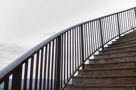 Metal handrails in the park against the background of the sky