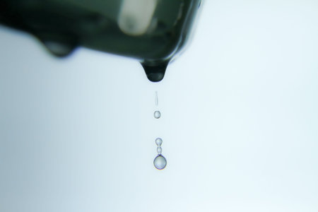 Drops of water on a white background. Shallow depth of field.