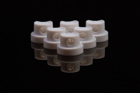 close-up of component caps, lids, tubes for aerosol cans and sprayers of chemicals and perfumes. Parts used in the aerosol industryの写真素材