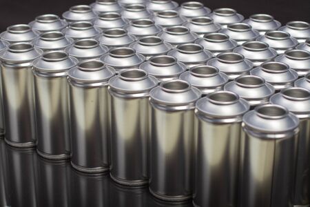 A large number of aerosol cans on a black backgroundの写真素材