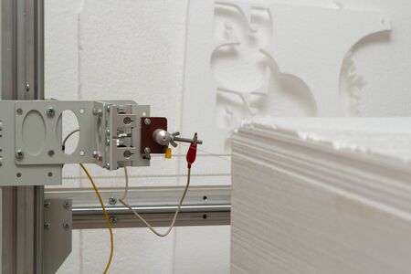 Small private production for cutting out products and figures made of foam on a machine with...