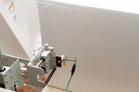 Small private production for cutting out products and figures made of foam on a machine with...