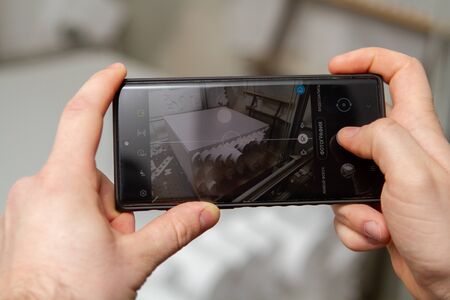 Small private production for cutting out products and figures made of foam on a machine with electric heating. Production of insulation for pipesの写真素材