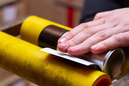 manual application of stickers on aerosol cans with automotive and other chemical compositionの写真素材