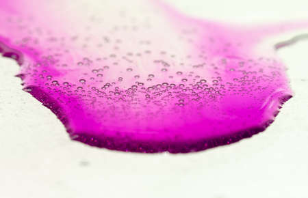 Water drops on glass on pink backgroundの写真素材
