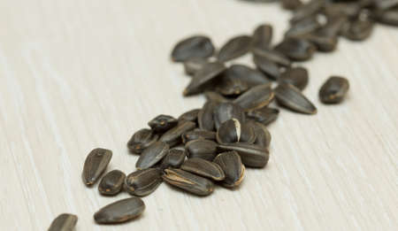 Black sunflower seeds on the white tableの写真素材