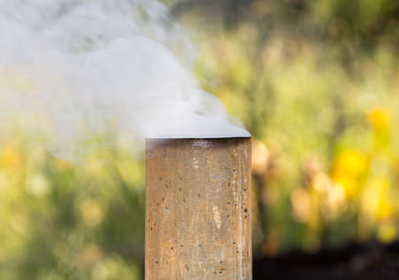 White smoke from the chimney of a samovar outdoorsの写真素材