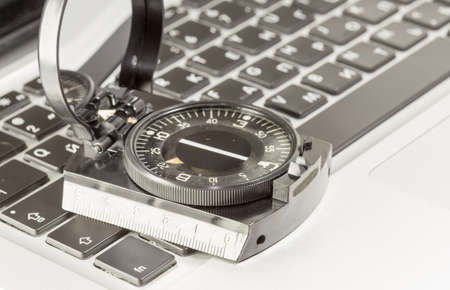 Global Web, wireless of GPS-navigation internet technology and success in business concept: Magnetic compass on a laptop or notebook PC keyboardの写真素材