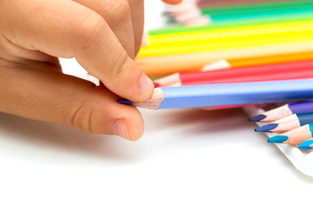 Colored pencils and finger kid macroの写真素材