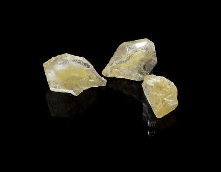raw, yellow, precious stones on a black backgroundの写真素材