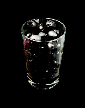black olives in a glass cupの写真素材