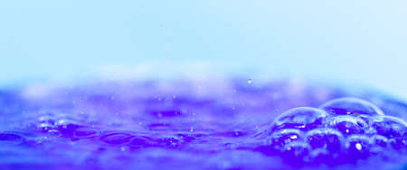 in a glass of blue cocktail with bubbles close-upの写真素材