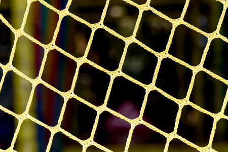 yellow mesh of rope on a black background