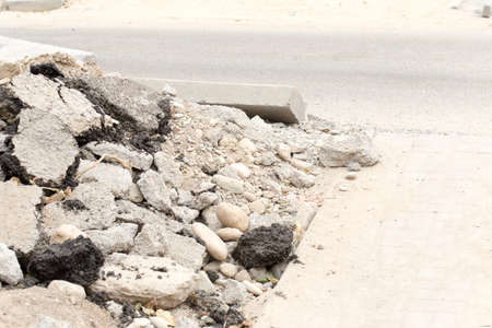 Background old cracked asphalt road scrap heap damage on the ground to be recycled.