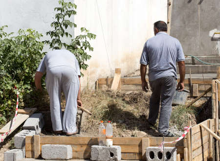 two man pours concrete for lestnitsa Around the houseの写真素材