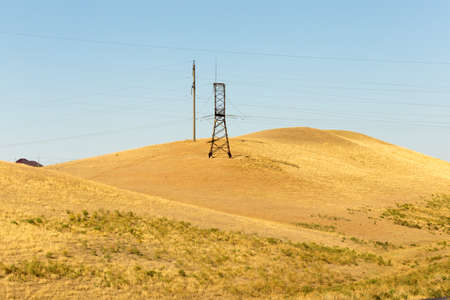 electric pole power lines and wires with blue skyの写真素材