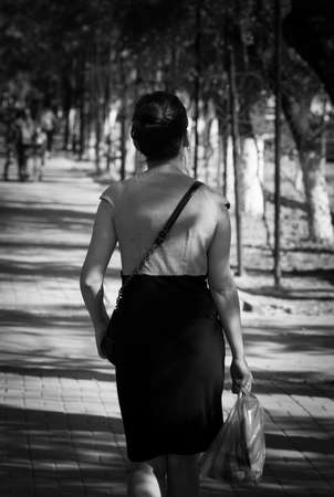 photo black and white girl on the sidewalkの写真素材