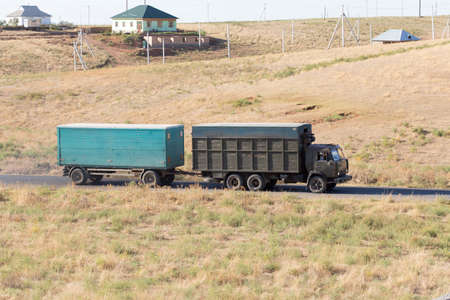 Truck passing by on a green agricultural fieldの写真素材