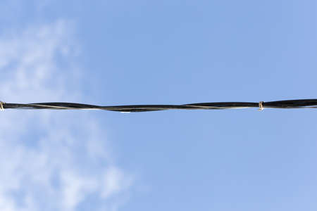 electrical wire against the bkue sky.の写真素材
