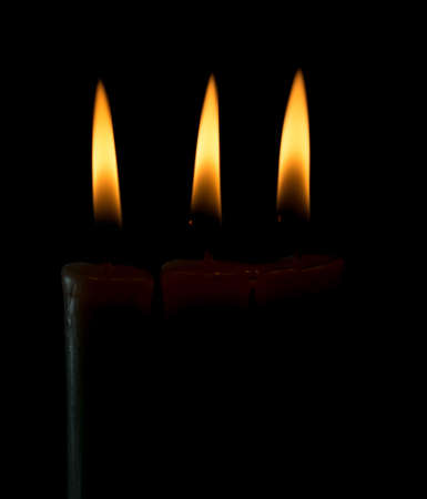 candle lit brightly against a black backgroundの写真素材