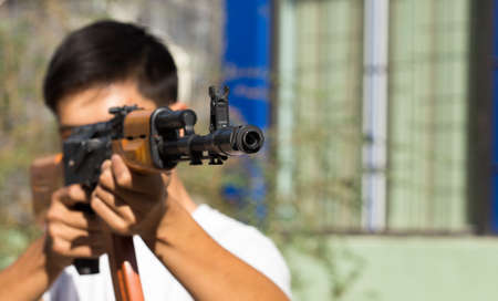 Portrait of a man aiming a gun