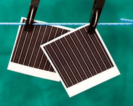 clothespin to hang a blank photo paperの写真素材