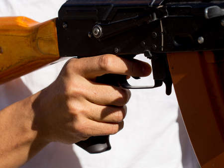 Portrait of a man aiming a gunの写真素材