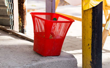 Plastic red bucket for debris in the yardの写真素材