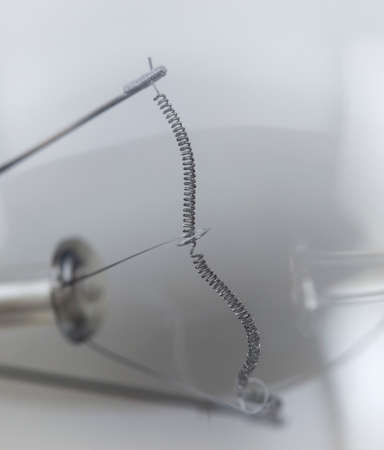 Chromed spiral on a light bulb, macro