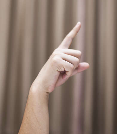Hand of a man on a background of brown clothの写真素材