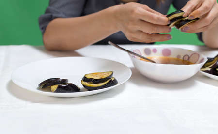 Girl preparing food on a table from eggplantの写真素材