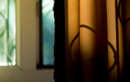 Beautiful view on sunset from home window curtainsの写真素材