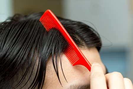 man combing hairの写真素材