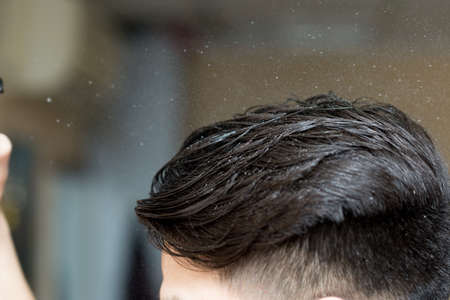 hair combed back to a young man's head close-upの写真素材