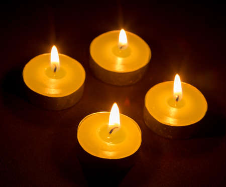 Group of burning candles on black backgroundの写真素材