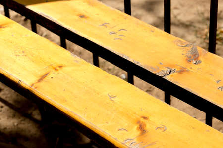 Close-up of a wooden bench in the sunshineの写真素材